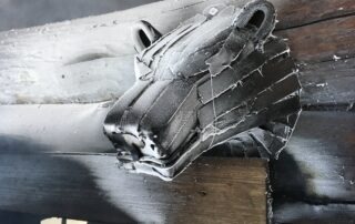 A frost‑covered bear head above the entrance of Jantsu’s traditional Estonian smoke sauna.