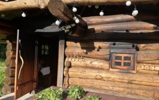 Front view of the smoke sauna in warm summer sunlight