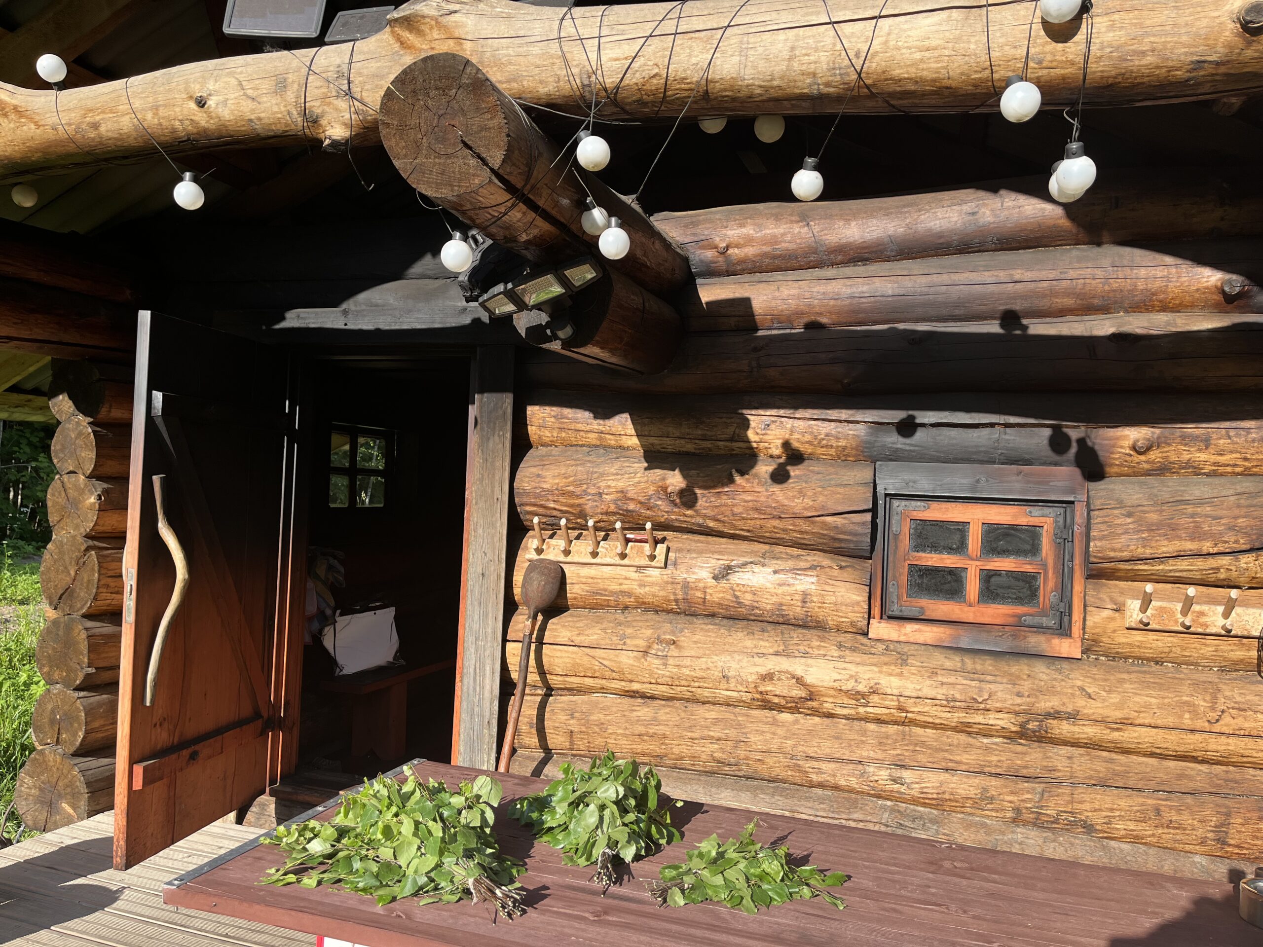 Front view of the smoke sauna in warm summer sunlight